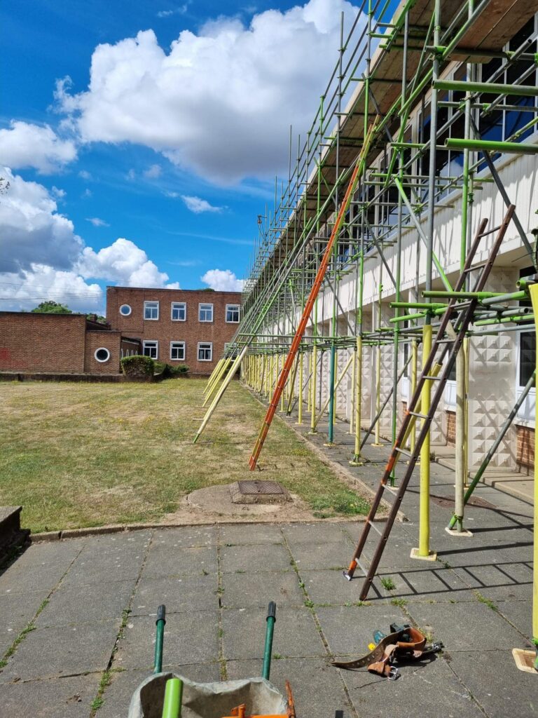 Commercial scaffolding on a white building with 2 levels